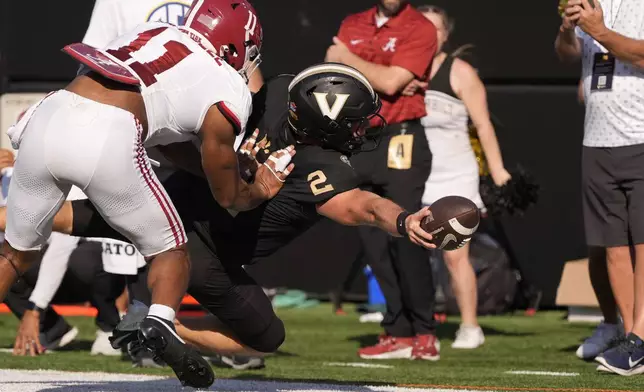 Vanderbilt quarterback Diego Pavia (2) dives for extra yards past Alabama linebacker Jihaad Campbell (11) during the first half of an NCAA college football game Saturday, Oct. 5, 2024, in Nashville, Tenn. (AP Photo/George Walker IV)