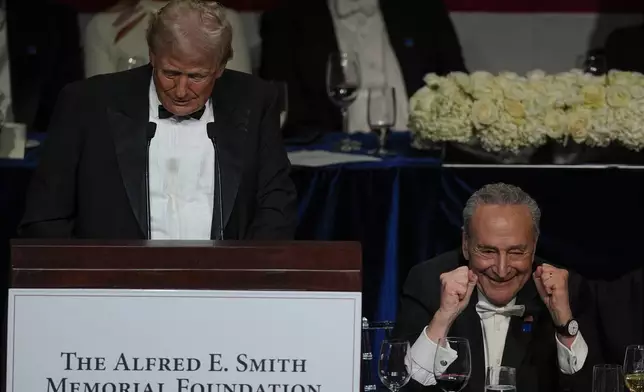 Republican presidential nominee former President Donald Trump speaks as Senate Majority Leader Chuck Schumer of N.Y., gestures at the 79th annual Alfred E. Smith Memorial Foundation Dinner, Thursday, Oct. 17, 2024, in New York. (AP Photo/Julia Demaree Nikhinson)