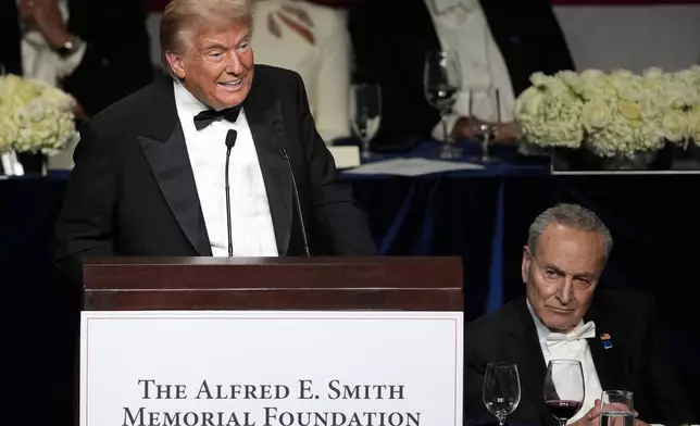 Republican presidential nominee former President Donald Trump speaks as Senate Majority Leader Chuck Schumer of N.Y., listens at the 79th annual Alfred E. Smith Memorial Foundation Dinner, Thursday, Oct. 17, 2024, in New York. (AP Photo/Julia Demaree Nikhinson)