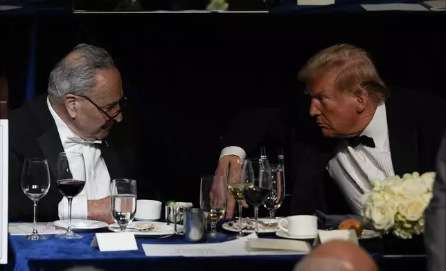 Republican presidential nominee former President Donald Trump talks with Senate Majority Leader Chuck Schumer of N.Y., at the 79th annual Alfred E. Smith Memorial Foundation Dinner, Thursday, Oct. 17, 2024, in New York. (AP Photo/Julia Demaree Nikhinson)