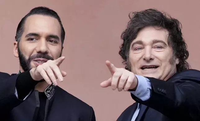 Argentine President Javier Milei, right, and El Salvador's President Nayib Armando Bukele point from a balcony during Bukele's visit to the government house in Buenos Aires, Argentina, Monday, Sept. 30, 2024. (AP Photo/Natacha Pisarenko)