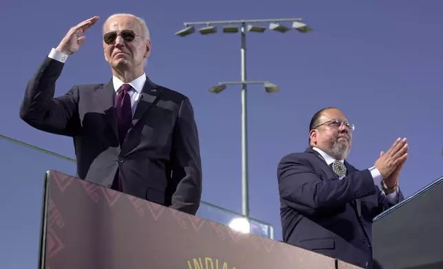 President Joe Biden, left, joined by Stephen Roe Lewis, Governor of the Gila River Indian Community, arrives to speak at the Gila Crossing Community School in the Gila River Indian Community reservation in Laveen, Ariz., Friday, Oct. 25, 2024. (AP Photo/Manuel Balce Ceneta)