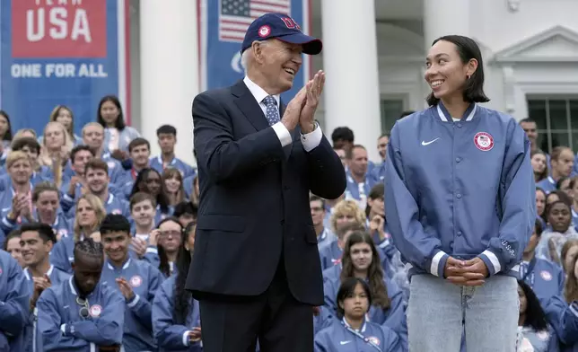 President Joe Biden, left, and Olympic swimmer Torri Huske attend an event celebrating the 2024 U.S. Olympic and Paralympic teams on the South Lawn of the White House in Washington, Monday, Sept. 30, 2024. (AP Photo/Susan Walsh)