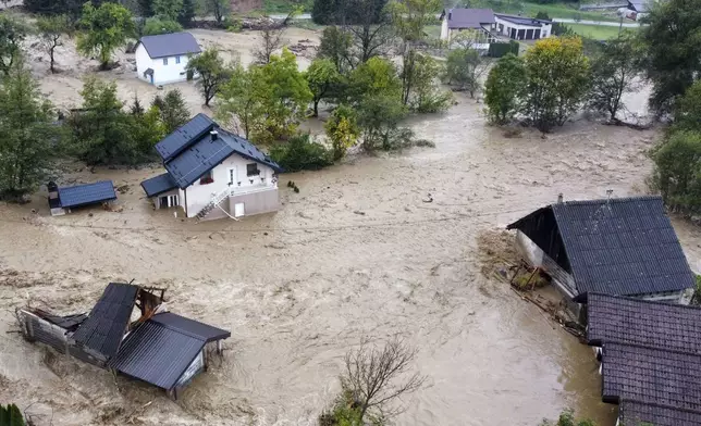 Flooded houses after a heavy rain in the village of Luke, near Bosnian town of Fojnica, 50 kms west of Sarajevo, Bosnia, Friday, Oct. 4, 2024. (AP Photo/Robert Oroz)