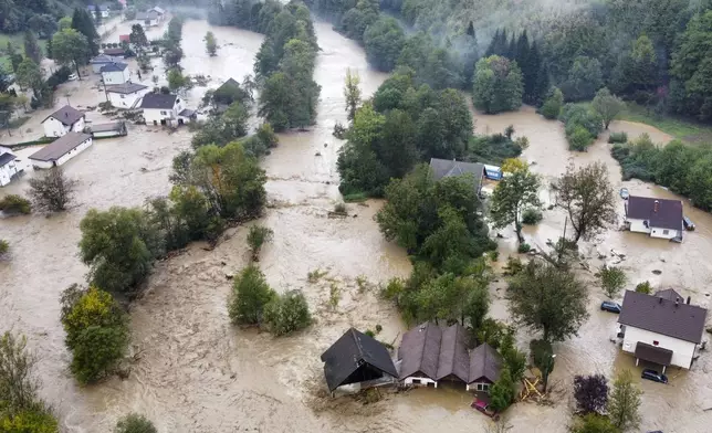 Flooded houses after a heavy rain in the village of Luke, near Bosnian town of Fojnica, 50 kms west of Sarajevo, Bosnia, Friday, Oct. 4, 2024. (AP Photo/Robert Oroz)