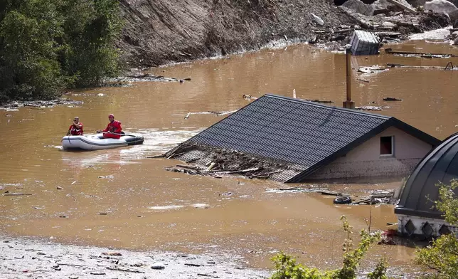 Search and rescue teams look for people in the flooded houses in Jablanica, Bosnia, Friday, Oct. 4, 2024. (AP Photo/Armin Durgut)