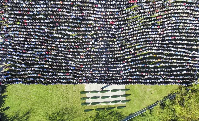 Mourners gather as they attend the collective funeral for 19 victims of a landslide caused by recent floods in Jablanica, Bosnia, Tuesday, Oct. 15, 2024. (AP Photo/Armin Durgut)