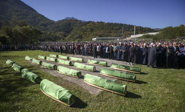 Coffins are displayed during the funeral service for victims of recent floods in Jablanica, Bosnia, Tuesday, Oct. 15, 2024. (AP Photo/Armin Durgut)