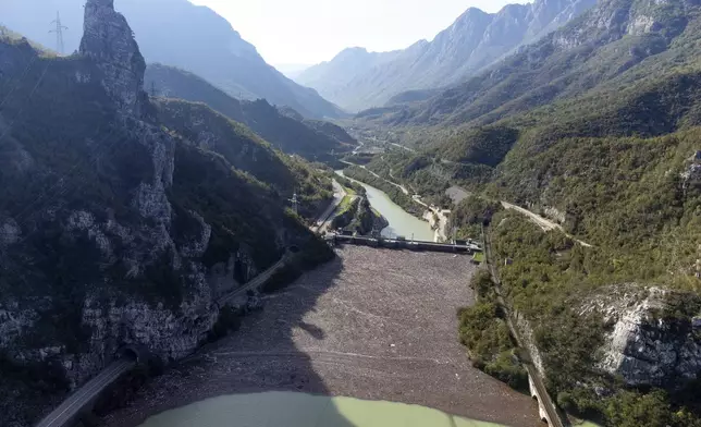 Aerial view of waste stuck at the dam on the Neretva river caused by landslides, torrential rain and flash floods in Grabovica, Bosnia, Sunday, Oct. 13, 2024. (AP Photo/Armin Durgut)