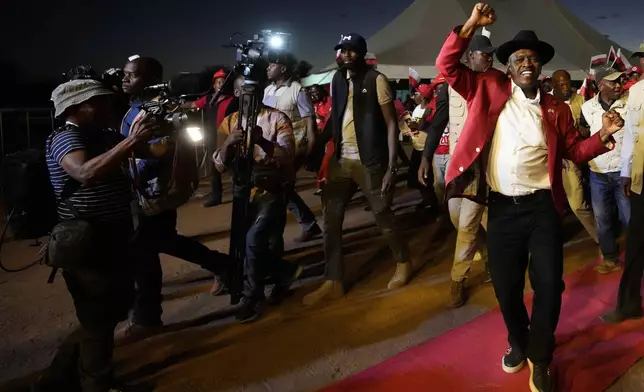 Botswana's President and Democratic Party leader Mokgweetsi Masisi dances during his election rally, a day before elections in Gaborone, Botswana, Tuesday, Oct. 29, 2024. (AP Photo/Themba Hadebe)