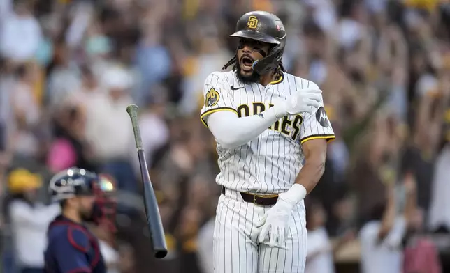 San Diego Padres' Fernando Tatis Jr. tosses his bat after hitting a two-run home run during the first inning in Game 1 of an NL Wild Card Series baseball game against the Atlanta Braves, Tuesday, Oct. 1, 2024, in San Diego. (AP Photo/Gregory Bull)