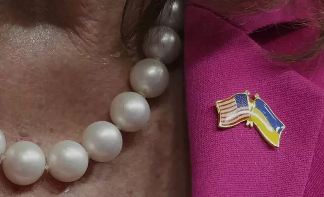 Former U.S. Speaker of the House of Representatives, Nancy Pelosi, wears a pin featuring American and Ukraine flags as she speaks at Chatham House to discuss challenges to American democracy and the importance of leadership in an election year in London, Monday, Oct. 14, 2024. (AP Photo/Kin Cheung)