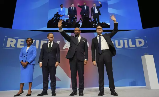 Conservative leadership candidates Kemi Badenoch, from left, Robert Jenrick, James Cleverly and Tom Tugendhat stand on the podium during the Conservative Party Conference at the International Convention Centre in Birmingham, England, Wednesday, Oct. 2, 2024.(AP Photo/Kin Cheung)