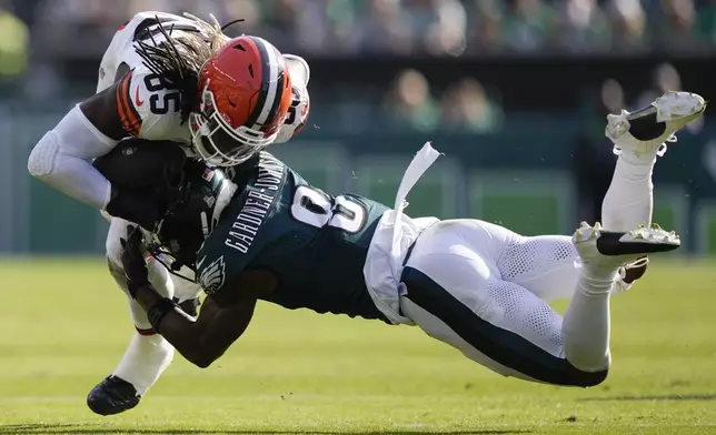 Philadelphia Eagles safety C.J. Gardner-Johnson (8) stops Cleveland Browns tight end David Njoku (85) during the second half of an NFL football game Sunday, Oct. 13, 2024, in Philadelphia. (AP Photo/Matt Rourke)