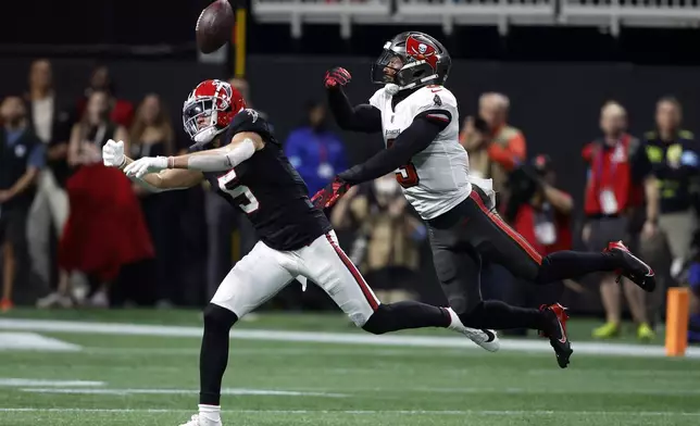 Tampa Bay Buccaneers safety Jordan Whitehead (3) breaks up a pass intended for Atlanta Falcons wide receiver Drake London (5) during the first half of an NFL football game Thursday, Oct. 3, 2024, in Atlanta. (AP Photo/Butch Dill)