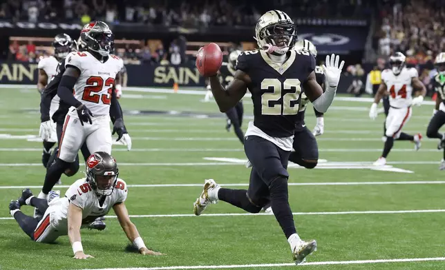 New Orleans Saints' Rashid Shaheed (22) gestures while returning a punt for a touchdown past Tampa Bay Buccaneers punter Jake Camarda (5) during the first half of an NFL football game in New Orleans, Sunday, Oct. 13, 2024. (AP Photo/Butch Dill)