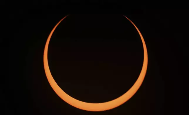 The moon moves across the sun during an annular solar eclipse seen from Tahai, Rapa Nui, or Easter Island, Chile, Wednesday, Oct. 2, 2024. (AP Photo/Esteban Felix)