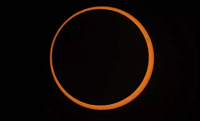 The moon moves across the sun during an annular solar eclipse in Tahai, Rapa Nui, or Easter Island, Chile, Wednesday, Oct. 2, 2024. (AP Photo/Esteban Felix)