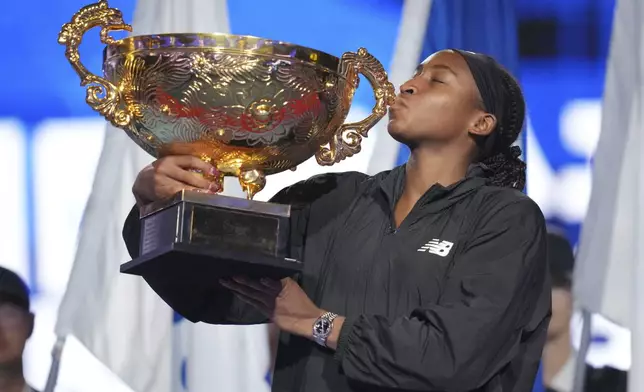 Coco Gauff of the United States kisses the trophy after defeating Karolina Muchova of Czech Republic in the women's singles final match at the China Open tennis tournament at the National Tennis Center in Beijing, Sunday, Oct. 6, 2024. (AP Photo/Achmad Ibrahim)