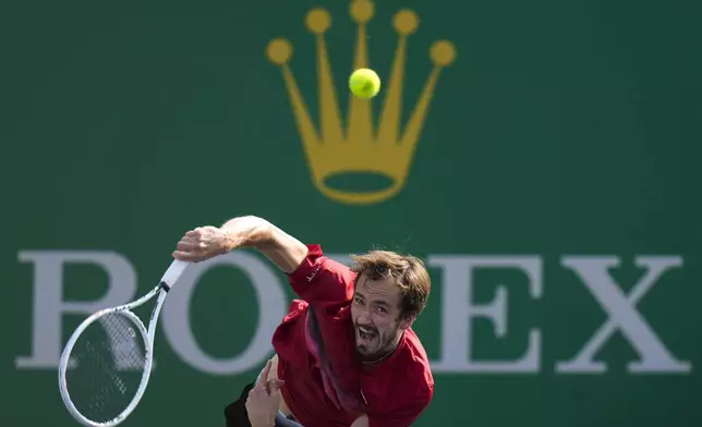 Daniil Medvedev of Russia serves against Stefanos Tsitsipas of Greece during the men's singles fourth round match in the Shanghai Masters tennis tournament at Qizhong Forest Sports City Tennis Center in Shanghai, China, Wednesday, Oct. 9, 2024. (AP Photo/Andy Wong)