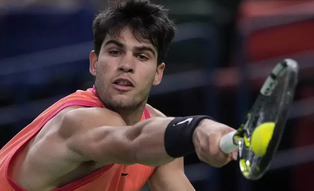 Carlos Alcaraz of Spain plays a backhand return against Tomas Machac of the Czech Republic during the men's singles quarterfinals match in the Shanghai Masters tennis tournament at Qizhong Forest Sports City Tennis Center in Shanghai, China, Thursday, Oct. 10, 2024. (AP Photo/Andy Wong)