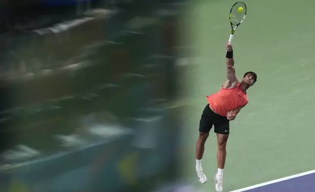 Carlos Alcaraz of Spain serves against Tomas Machac of the Czech Republic during the men's singles quarterfinals match in the Shanghai Masters tennis tournament at Qizhong Forest Sports City Tennis Center in Shanghai, China, Thursday, Oct. 10, 2024. (AP Photo/Andy Wong)