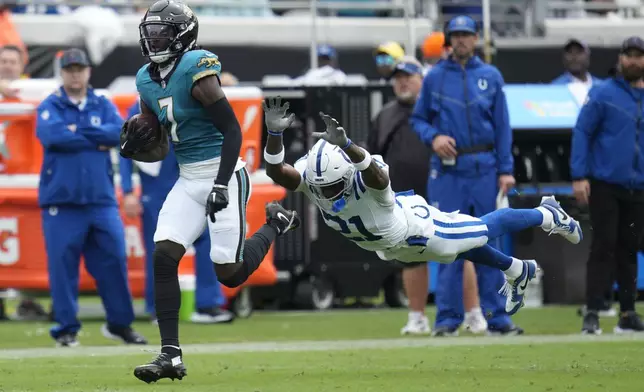 Jacksonville Jaguars' Brian Thomas Jr. (7) runs past Indianapolis Colts' Dallis Flowers (21) for a touchdown during the first half of an NFL football game, Sunday, Oct. 6, 2024, in Jacksonville, Fla. (AP Photo/John Raoux)