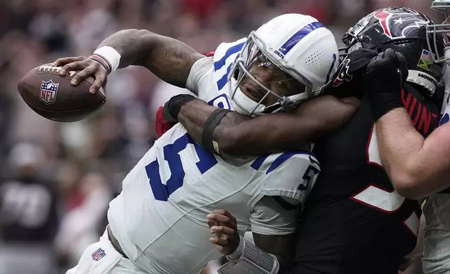 Indianapolis Colts quarterback Anthony Richardson (5) is sacked by Houston Texans defensive end Danielle Hunter (55) during the second half of an NFL football game, Sunday, Oct. 27, 2024, in Houston. (AP Photo/Tony Gutierrez)