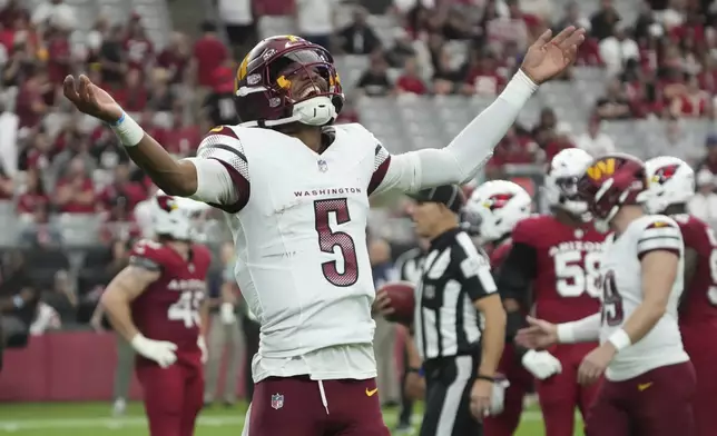 Washington Commanders quarterback Jayden Daniels (5) celebrates a touchdown against the Arizona Cardinals during the second half of an NFL football game, Sunday, Sept. 29, 2024, in Glendale, Ariz. (AP Photo/Rick Scuteri)