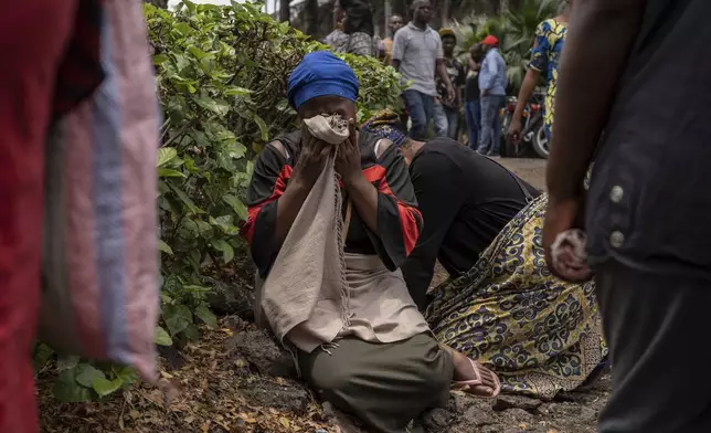 Women grieve at the port of Goma, Democratic Republic of Congo, after a ferry carrying hundreds capsized on arrival Thursday, Oct. 3, 2024. (AP Photo/Moses Sawasawa)