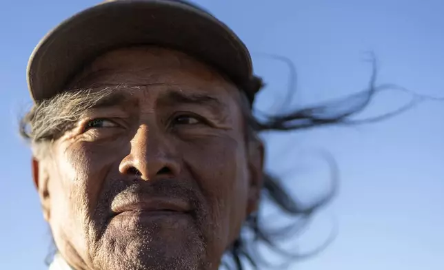 Navajo Richard Begay poses for a portrait while taking a break from herding his goats, on the Navajo Nation in Dilkon, Ariz., Thursday, Oct. 17, 2024. Native people were first recognized as U.S. citizens 100 years ago, but Arizona prevented them from exercising their right to vote until 1948. (AP Photo/Rodrigo Abd)