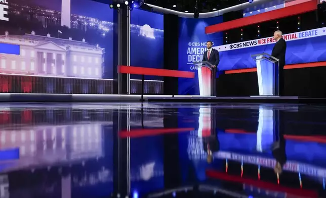 Republican vice presidential nominee Sen. JD Vance, R-Ohio, and Democratic vice presidential candidate Minnesota Gov. Tim Walz participate in a vice presidential debate hosted by CBS News Tuesday, Oct. 1, 2024, in New York. (AP Photo/Matt Rourke)