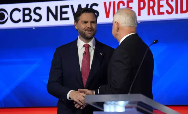 Republican vice presidential nominee Sen. JD Vance, R-Ohio, and Democratic vice presidential nominee Minnesota Gov. Tim Walz shake hands before the vice presidential debate hosted by CBS News Tuesday, Oct. 1, 2024, in New York. (AP Photo/Matt Rourke)