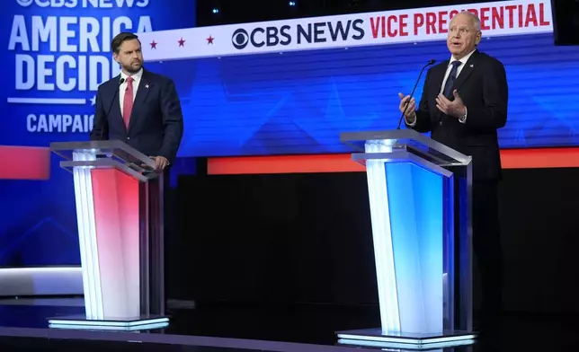 Republican vice presidential nominee Sen. JD Vance, R-Ohio, and Democratic vice presidential nominee Minnesota Gov. Tim Walz participate in vice presidential debate hosted by CBS News Tuesday, Oct. 1, 2024, in New York. (AP Photo/Matt Rourke)