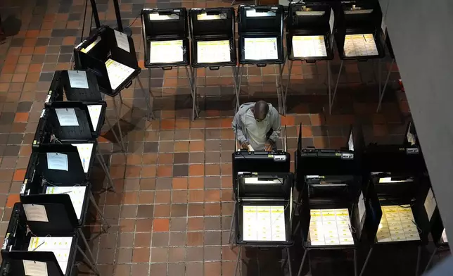 A person votes on the first day of early voting in the general election Monday, Oct. 21, 2024, in Miami. (AP Photo/Lynne Sladky)