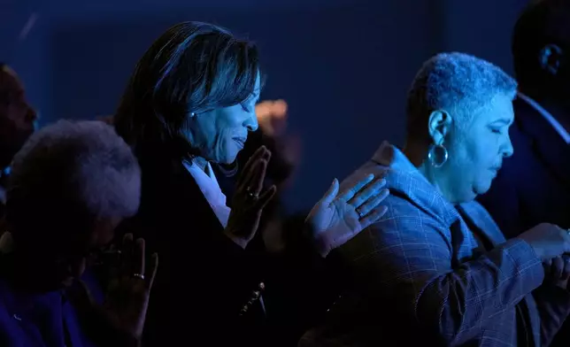 Democratic presidential nominee Vice President Kamala Harris, left, prays alongside bishop Rosie O'neal during a church service at Koinonia Christian Center in Greenville, N.C., Sunday, Oct. 13, 2024. (AP Photo/Susan Walsh)