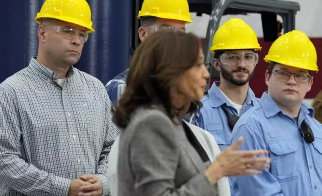 Employees listen as Democratic presidential nominee Vice President Kamala Harris speaks after touring the Hemlock Semiconductor Next-Generation Finishing facility in Hemlock, Mich., Monday, Oct. 28, 2024. (AP Photo/Jacquelyn Martin)