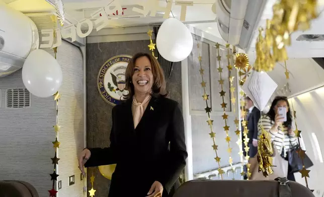 Democratic presidential nominee Vice President Kamala Harris is surprised by campaign staff with birthday decorations on Air Force Two before departing Hartsfield Jackson International Airport in Atlanta, Sunday, Oct. 20, 2024, en route to Philadelphia. (AP Photo/Jacquelyn, Martin, Pool)