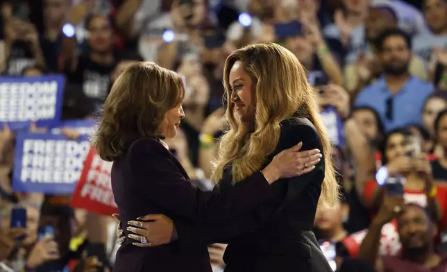 Musical artist Beyonce, right, and Democratic presidential nominee Vice President Kamala Harris, left, embrace on stage during a campaign rally Friday, Oct. 25, 2024, in Houston. (AP Photo/Annie Mulligan)