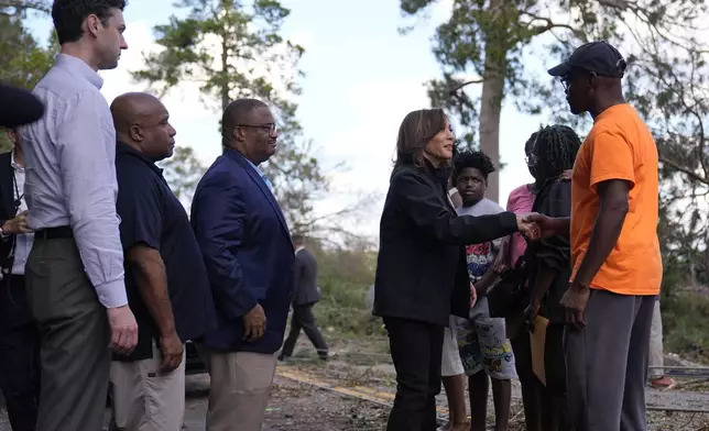 Democratic presidential nominee Vice President Kamala Harris greets people who were impacted by Hurricane Helene in Augusta, Ga., Wednesday, Oct. 2, 2024, as from left, Sen. Jon Ossoff, D-Ga., FEMA deputy direct Erik Hooks and Augusta Mayor Garnett Johnson watch. (AP Photo/Carolyn Kaster)