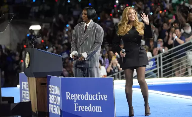 Musical artists Beyonce, right, and Kelly Rowland, left, on stage at a campaign event for Democratic presidential nominee Vice President Kamala Harris in Houston, Friday, Oct. 25, 2024. (AP Photo/Susan Walsh)