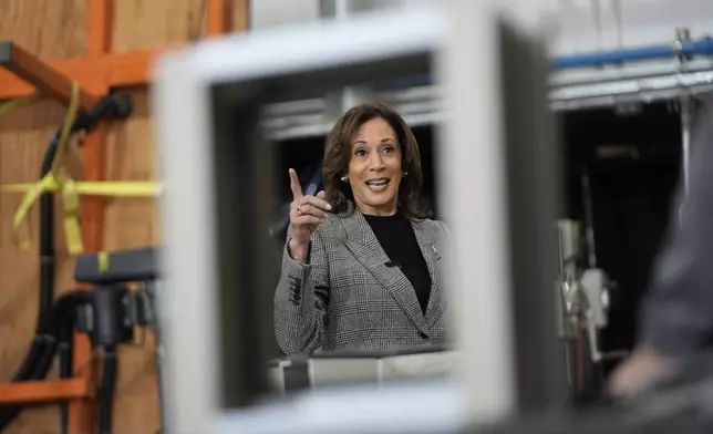 Democratic presidential nominee Vice President Kamala Harris tours the International Union of Painters and Allied Trades District Council 1M facilities, Monday, Oct. 28, 2024, in Warren, Mich. (AP Photo/Paul Sancya)