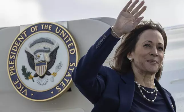 Democratic presidential nominee Vice President Kamala Harris waves as she boards Air Force Two at LaGuardia International Airport, Wednesday, Oct. 9, 2024, in New York. (AP Photo/Yuki Iwamura)