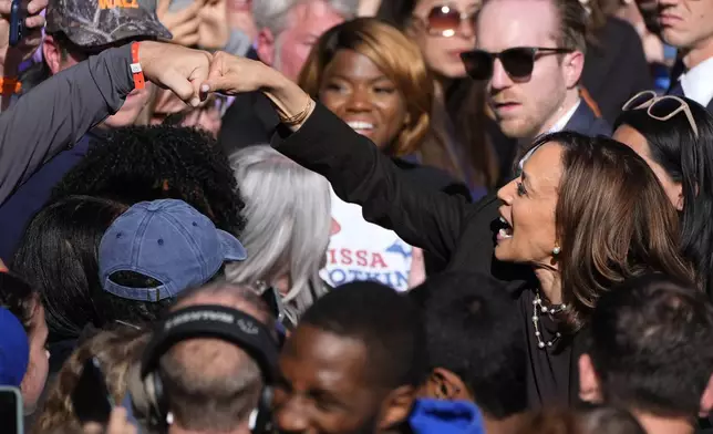 Democratic presidential nominee Vice President Kamala Harris fist-bumps a supporters after speaking at a campaign rally in Riverside Park, Friday, Oct. 18, 2024, in Grand Rapids, Mich. (AP Photo/Paul Sancya)