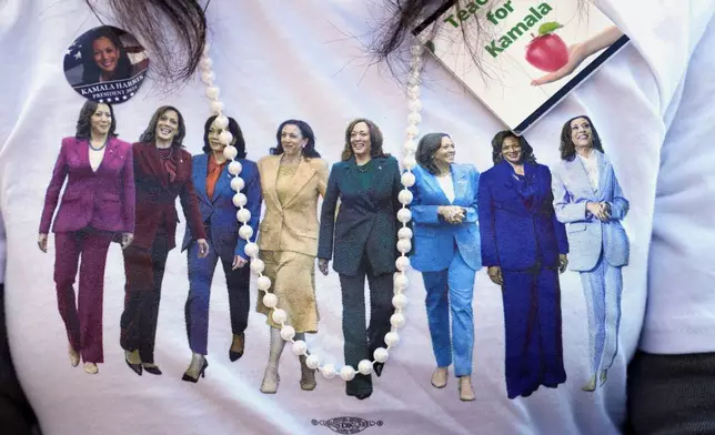 A supporter wears a campaign shirt as Democratic presidential nominee Vice President Kamala Harris speaks during a campaign event at Riverside Park in Grand Rapids, Mich., Friday, Oct. 18, 2024. (AP Photo/Jacquelyn Martin)