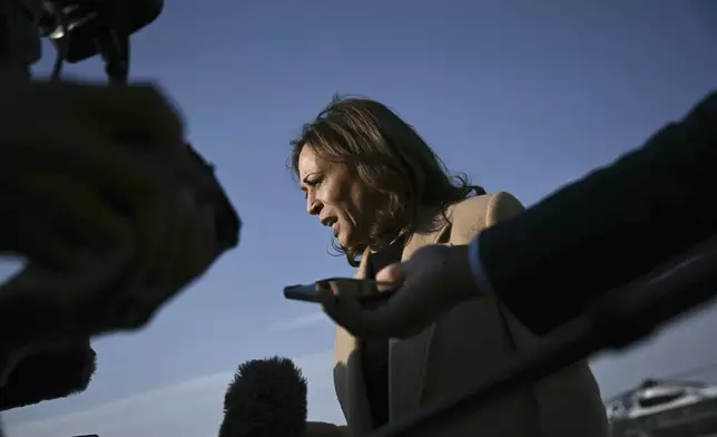 Democratic presidential nominee Vice President Kamala Harris speaks to the press before boarding Air Force Two at Joint Base Andrews, Md., Saturday, Oct. 12, 2024, en route to North Carolina for a campaign event. (Brendan Smialowski/Pool via AP)