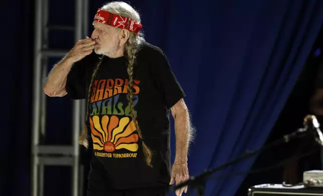 Willie Nelson blows a kiss to the crowd during a campaign rally for Democratic presidential nominee Vice President Kamala Harris, Friday, Oct. 25, 2024, in Houston. (AP Photo/Annie Mulligan)