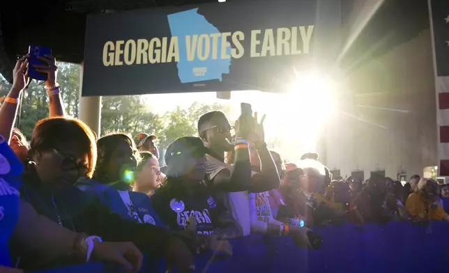 People arrive for a campaign event for Democratic presidential nominee Vice President Kamala Harris at Lakewood Amphitheatre, Saturday, Oct. 19, 2024, in Atlanta. (AP Photo/Jacquelyn Martin)