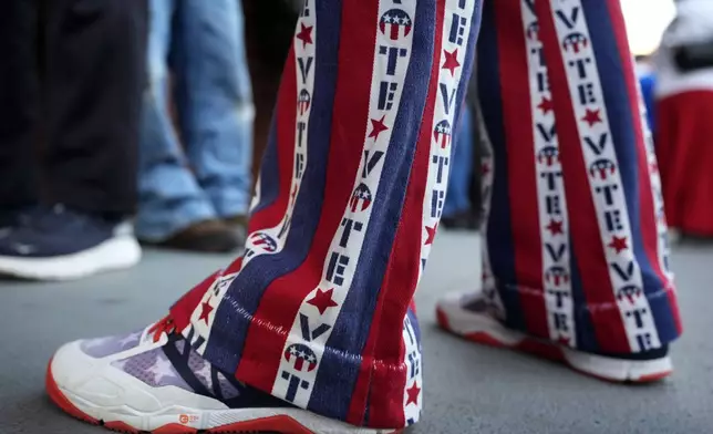 John Olsen, of Ankeny, Iowa, stands in line for early voting at the Polk County Election Office, Wednesday, Oct. 16, 2024, in Des Moines, Iowa. (AP Photo/Charlie Neibergall)