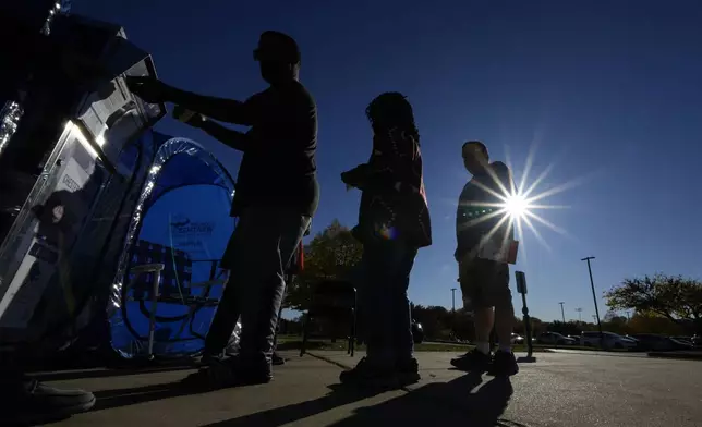 Voters return their mail-in ballots for the 2024 General Election in the United States outside the Chester County Government Services Center, Friday, Oct. 25, 2024, in West Chester, Pa. (AP Photo/Matt Slocum)